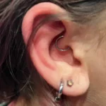 Daith piercing at Titan Piercing Montreal. The image displays a daith piercing, located in the innermost fold of the ear cartilage, showcasing the studio's precision and skill in performing intricate ear piercings.